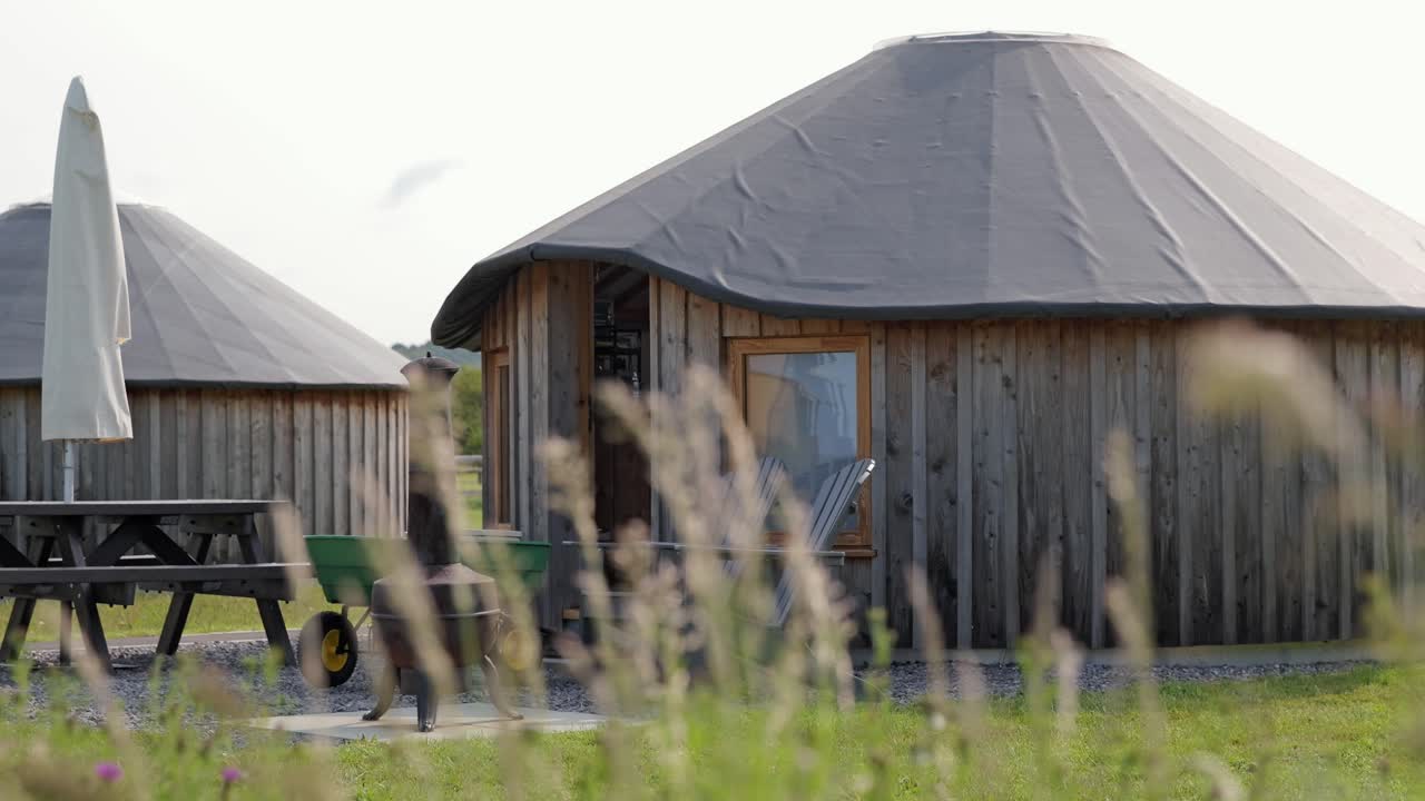 Wooden glamping huts and outdoor setup at Daleacres, summer travel scene