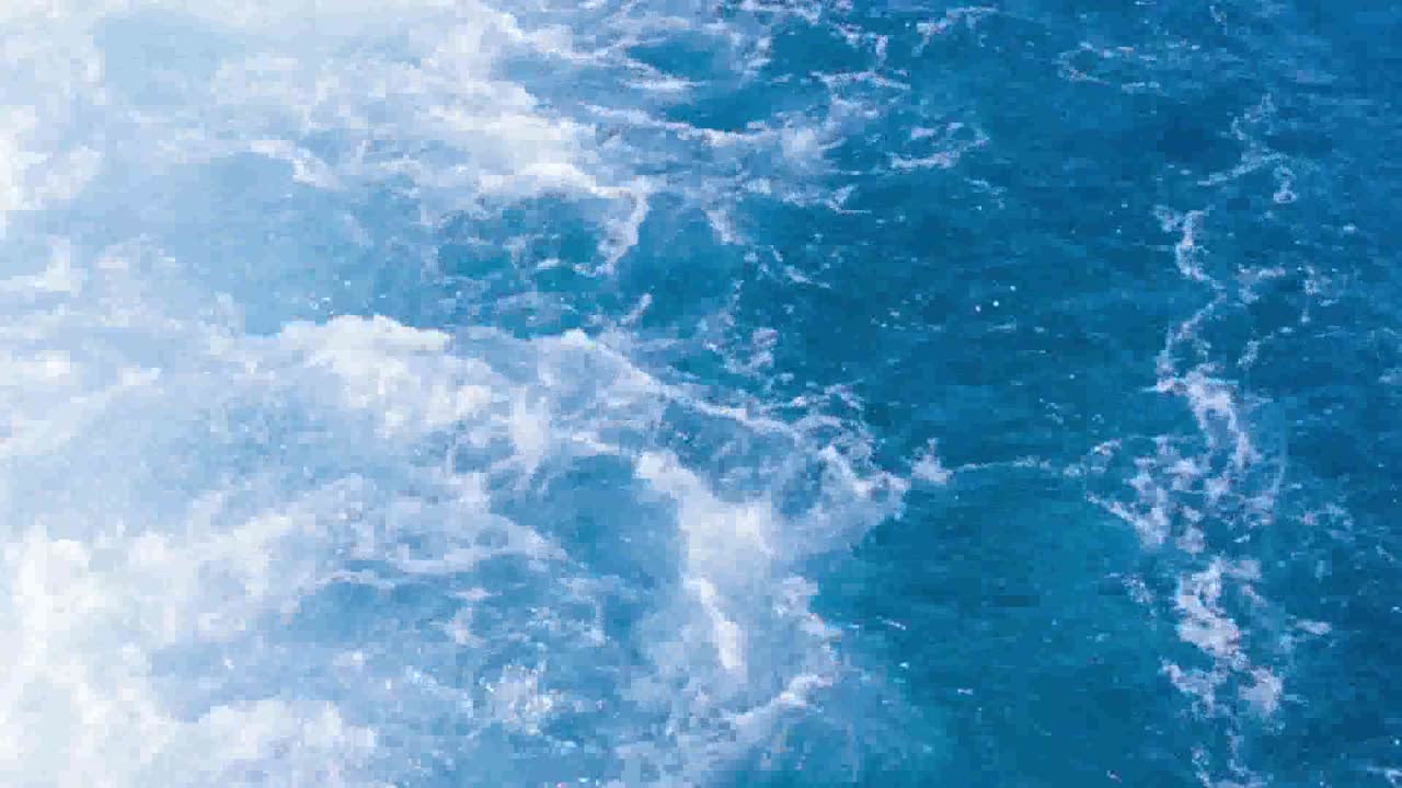 Water splashes behind a boat in Egypt, travel in Red Sea.