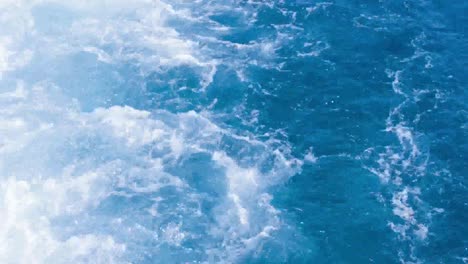 water splashes behind a boat in egypt, travel in red sea.
