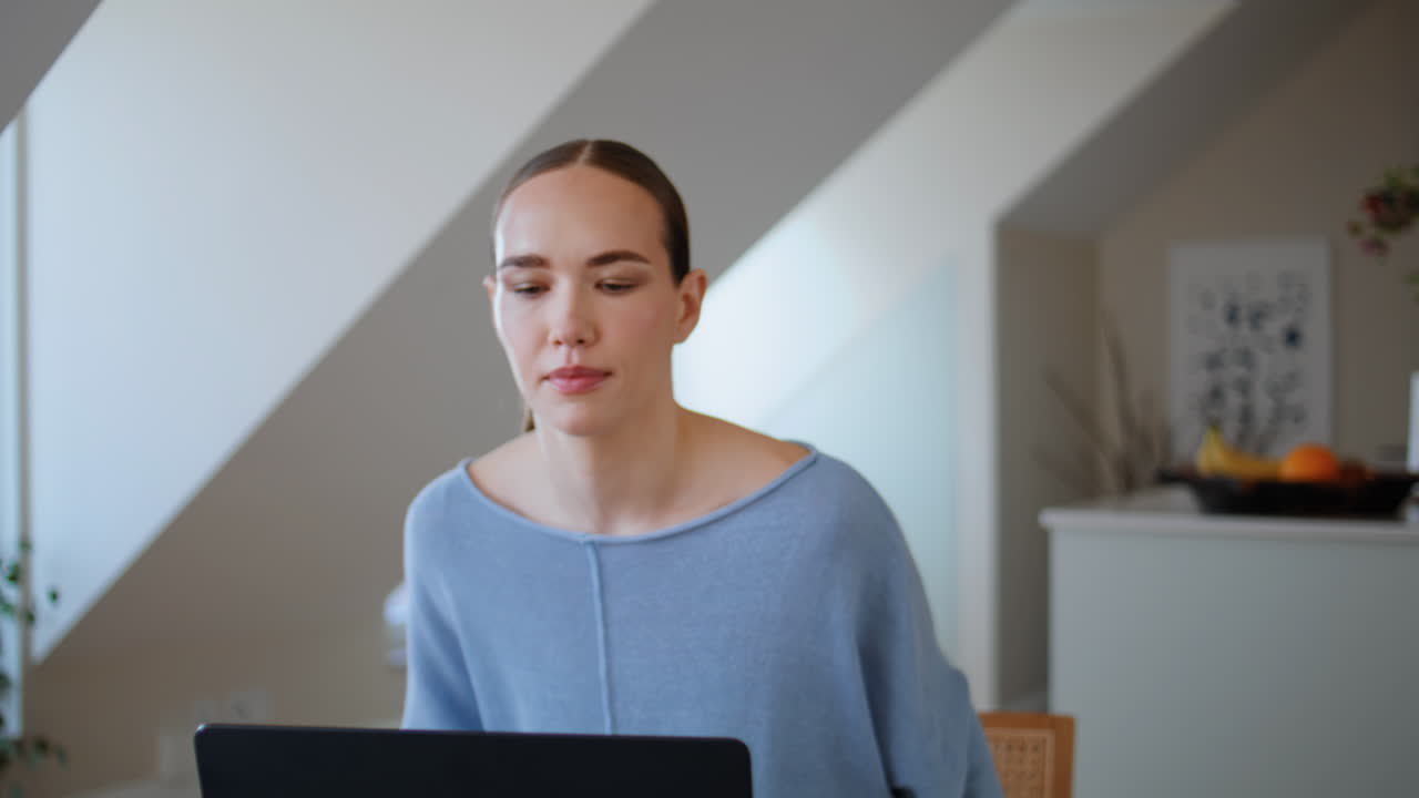 Awakened woman sipping cappuccino sitting workplace in morning kitchen closeup