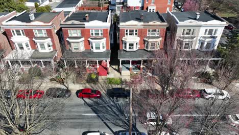 Beautiful-american-urban-residential-area-with-parking-cars-in-front-at-summer---Slow-aerial-tilt-down