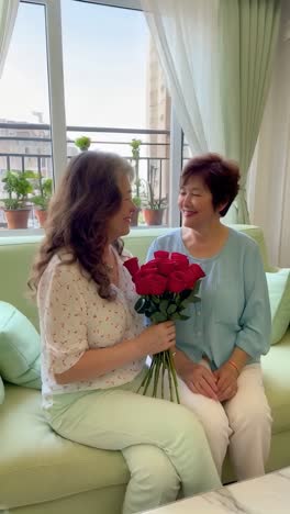 Older lesbian couple celebrating love at home. Valentine's Day