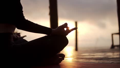 Silhouette-Of-Unrecognizable-Yogi-Girl-Sitting-In-Lotus-Pose-In-Front-The-Sea-In-Summer-On-Sunset-And-Meditating