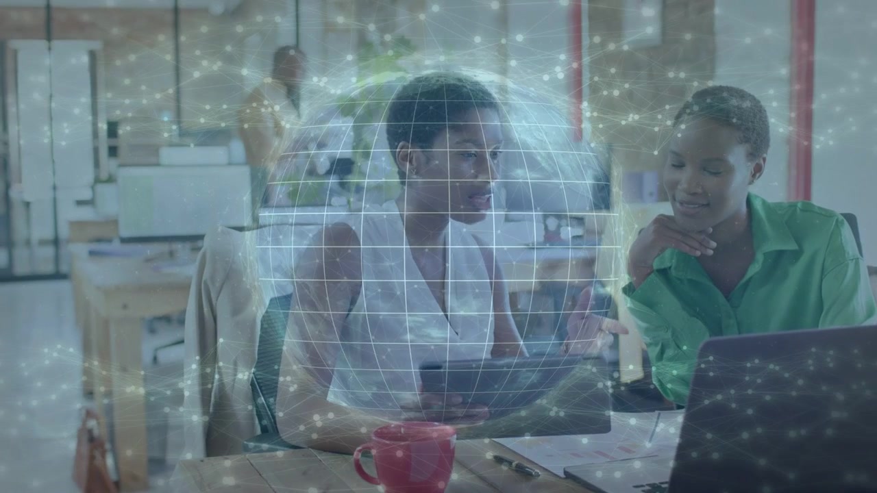 Left woman leaning and pointing at laptop, sparking digital globe pulsing peer tapping for business