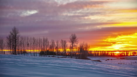 golden sunset cloudscape time lapse over a snowy, winter landscape