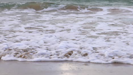 ocean waves gently hitting the sandy shore