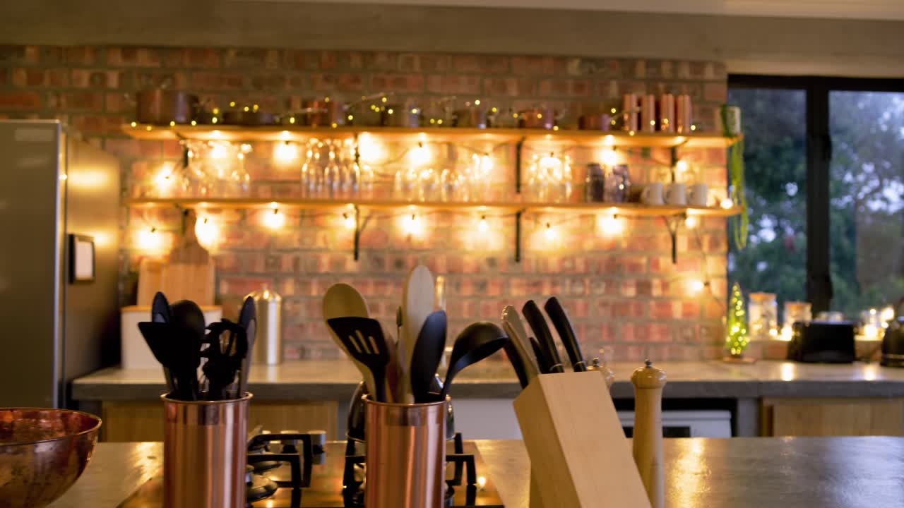 On start, camera is dollying and panning across kitchen, focusing on copper utensils