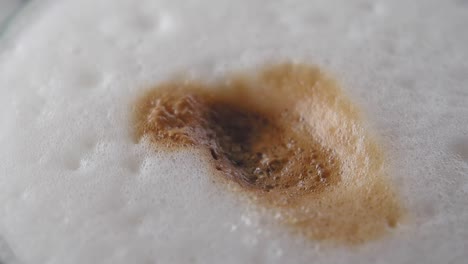 close-up of a cappuccino with sugar being added