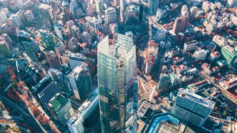 Aerial-timelapse-of-the-city-with-its-buildings-and-the-constant-traffic-of-cars-on-the-streets-at-dawn