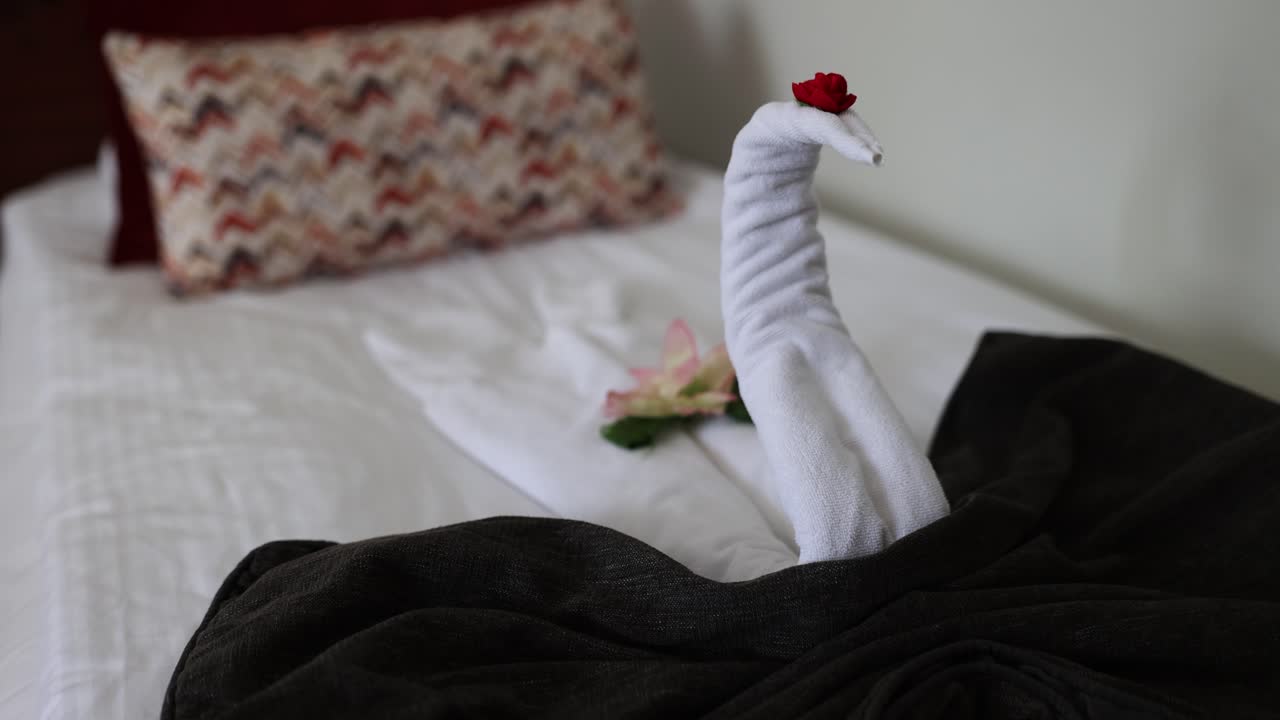 Elegant Towel Swan Decoration on a Hotel Bed