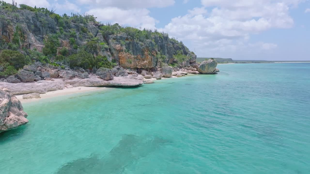 Transparent and shallow waters sea along rocky coast of Jaragua National Park, Pedernales in Dominican Republic