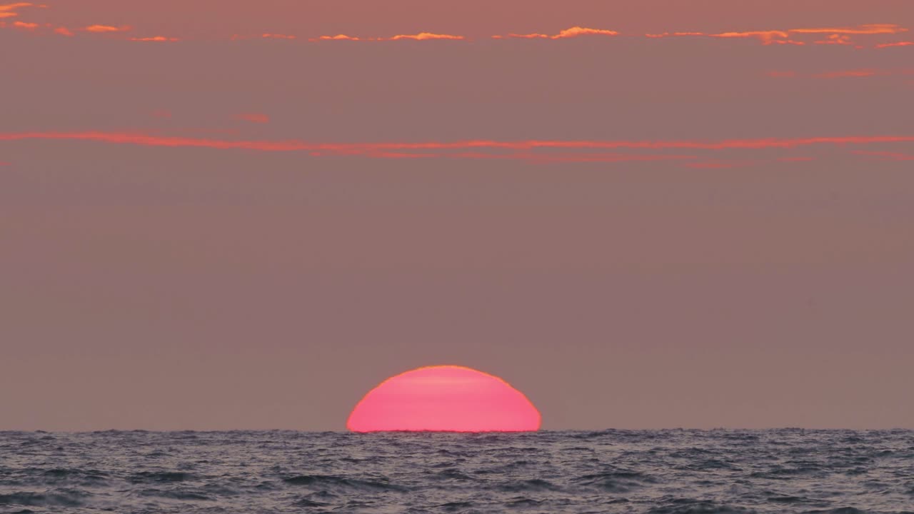Stunning Sunset over the Ocean with a Fishing Boat