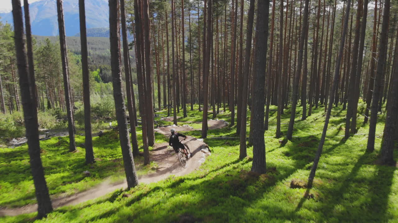 Epic mountain biking adventure above the fjords near Sogndal, Norway. Rider tackles rugged trails surrounded by dramatic cliffs, lush green hills, and stunning Nordic scenery