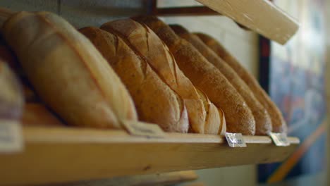 bread is lined up on a shelf