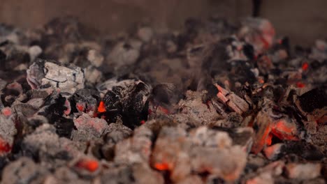 close up of smoldering and glowing burning coals