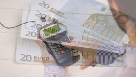 animation of euro banknotes falling over hand of caucasian man holding payment terminal