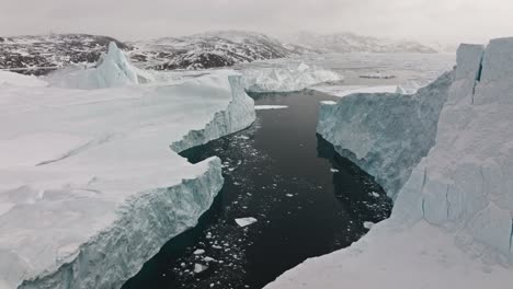 drone over sea and ice of ilulissat icefjord