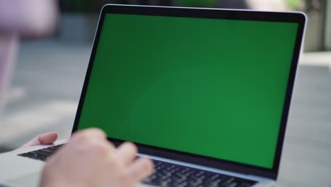 laptop with green screen close-up. girl student or it specialist uses laptop. 4k