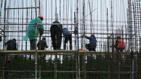 construction workers on scaffolding at a building site