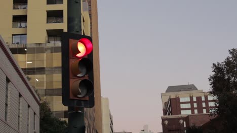 red traffic light in city at dusk