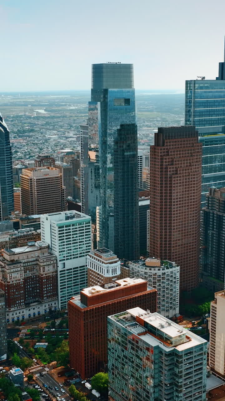 Philadelphia skyscrapers standing out among the New York architecture. Vast cityscape of the metropolis from top. Vertical video