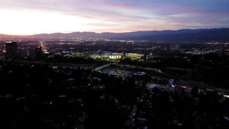 hollywood hills-studio city birds-eye-view at dusk. panoramic city view at sunset, towards universal studios and warner brothers. 9s sec.