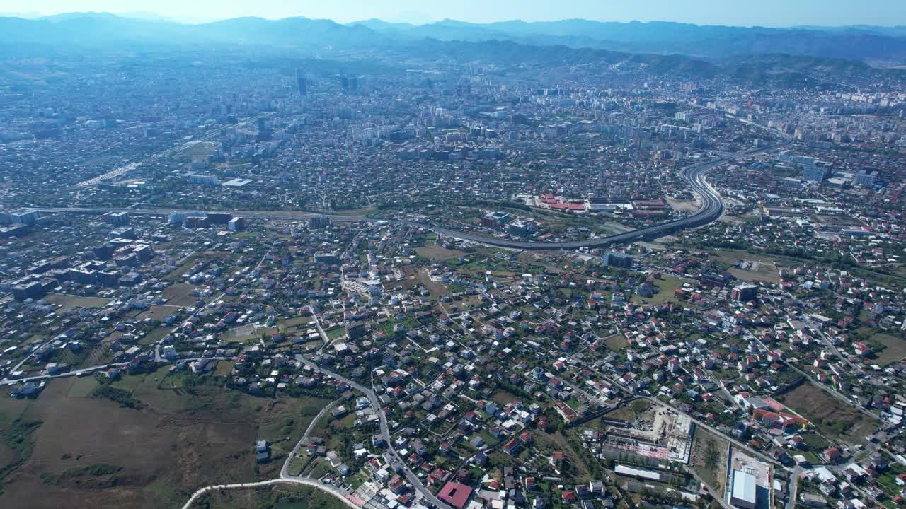 Tirana outskirts, overcrowded neighborhoods, urbanization challenges, real estate developments