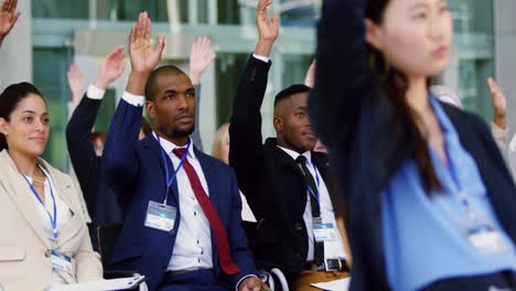 Business-people-raising-their-hands-in-a-business-seminar-4k