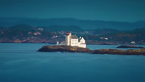 gronningen lighthouse stands on the tiny rocky islet on the coast near kristiansand, norway