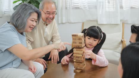 family playing with wooden blocks