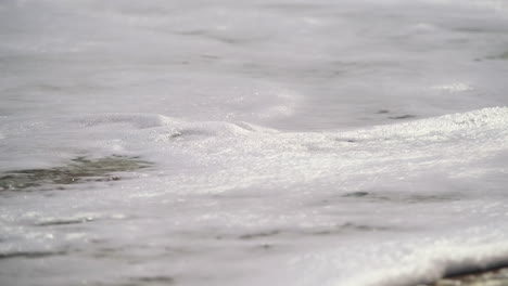 Low-angle-shot-Showing-Breaking-Waves-On-Sea-Shore-During-sunny-day