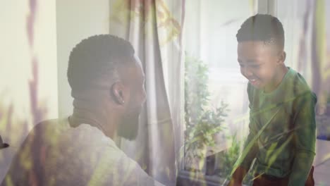 animación de hierba sobre feliz padre y hijo afroamericanos divirtiéndose en casa