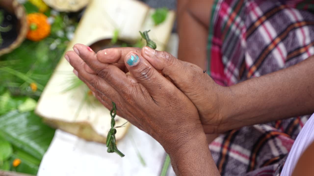 Woman Praying: A Close-Up View of Hands in Prayer During a Hindu Ritual