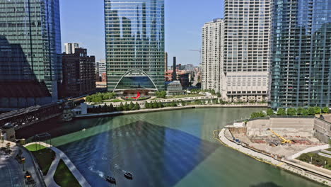 chicago illinois aerial v51 low level drone flyover narrow river course capturing surrounded high rise buildings and skyscrapers during daytime - august 2020