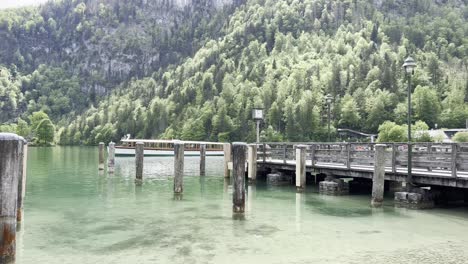 tourist boat leaving the boat dock at picturesque lake königssee near berchtesgaden in the bavarian alps