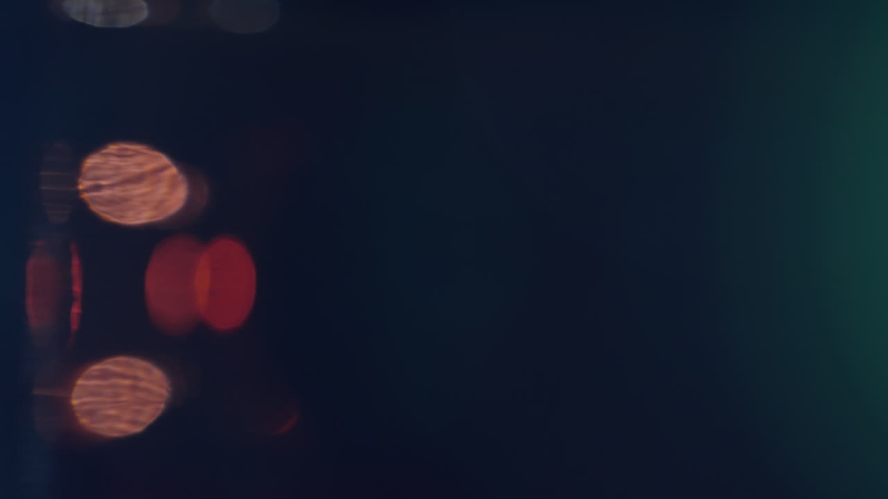 Elegant slow-motion bokeh in shimmering gold, blue, red, and silver hues. Analogue sparkle creates a luxurious feel, ideal for overlays, fashion visuals, or cinematic texture design.