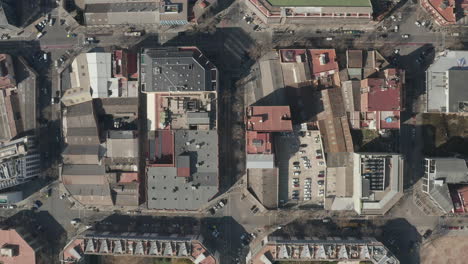 Birds-eye-of-buildings-in-city-from-above.-Fly-above-blocks-of-buildings-surrounded-by-streets.-Barcelona,-Spain