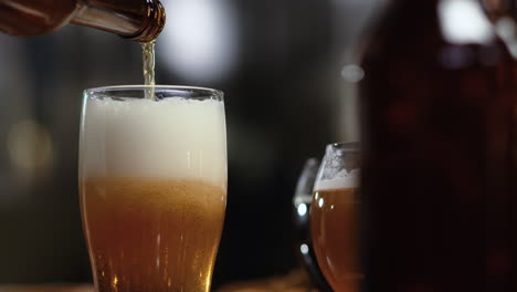 한 여자 가 컵 에 맥주 를 고 있다