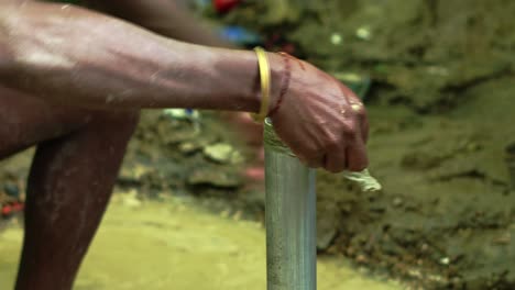 fontanero arreglando una bomba de agua en un pueblo remoto de áfrica