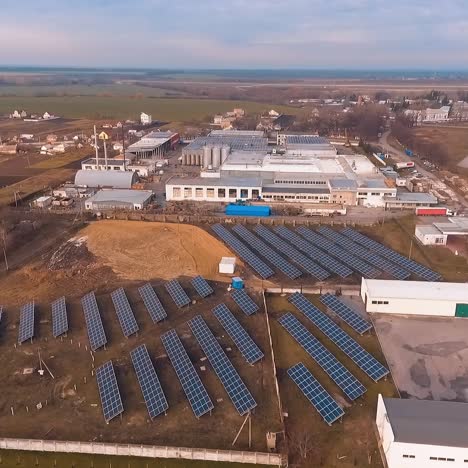 new industry in the countryside. solar panels on the field. sunny batteries receive ecological energy from the winter sunlight. alternative source of energy. aerial view.