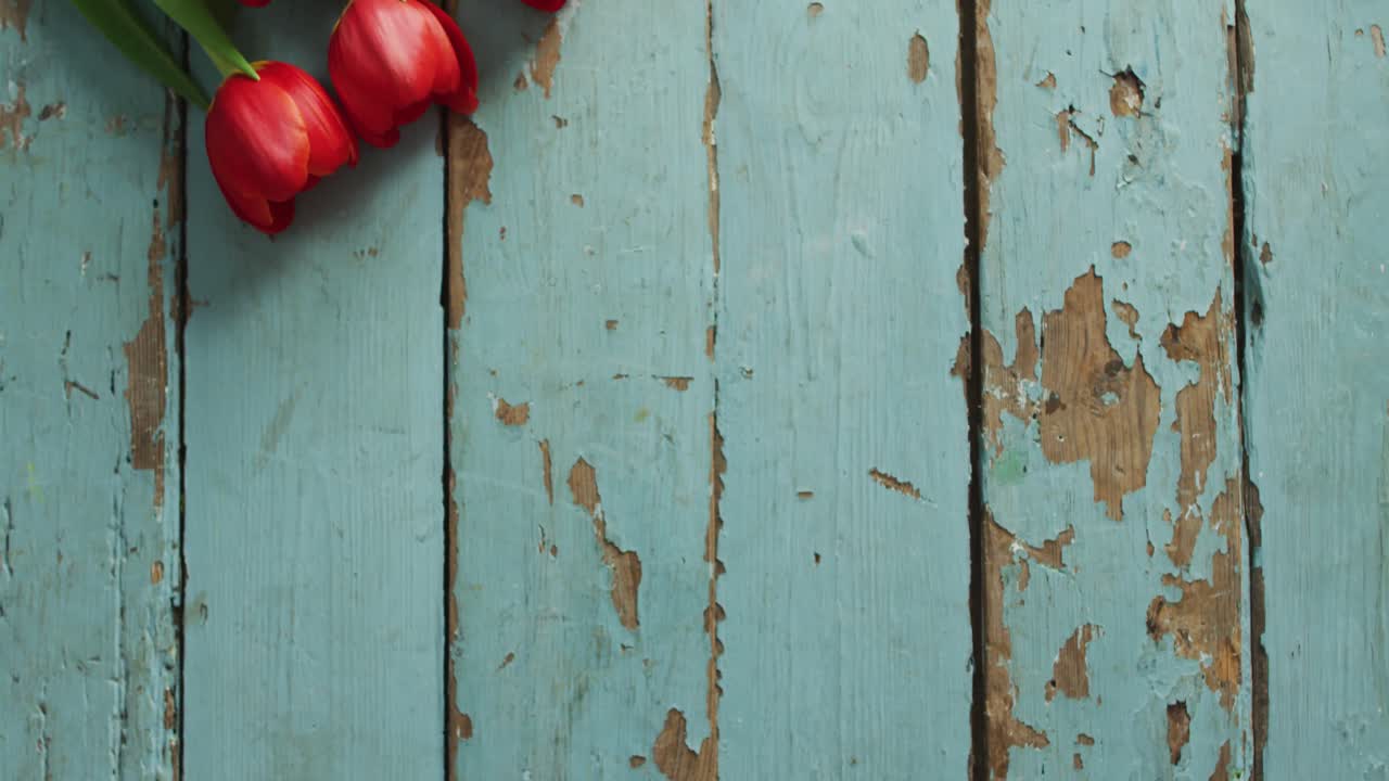 Bouquet of red tulips on wooden background at valentine's day