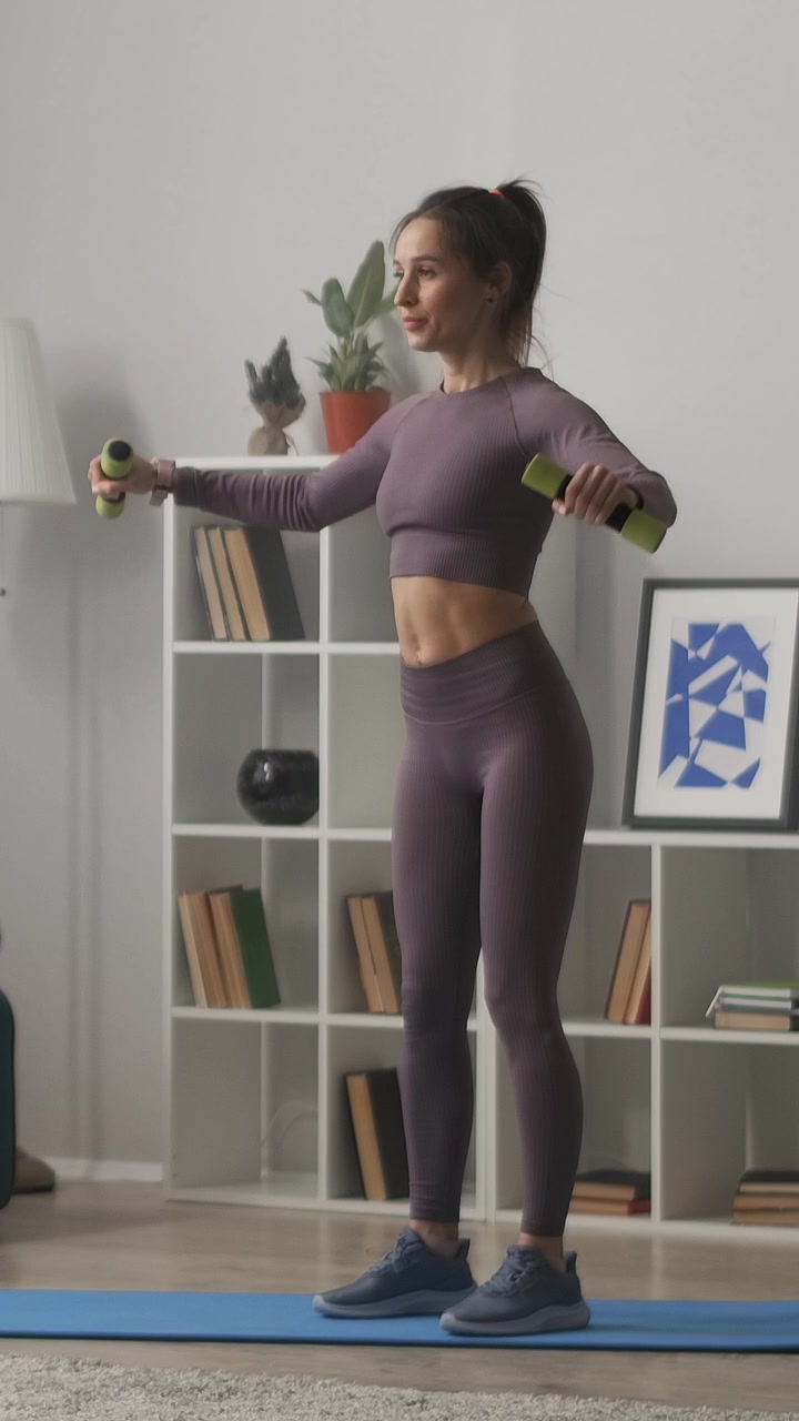 Woman Performing Lateral Raises with Dumbbells at Home