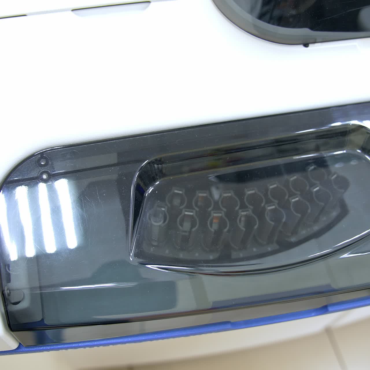 Transparent lid at the apparatus for blood testing. A set of test tubes moving inside the equipment. Innovative science laboratory technics