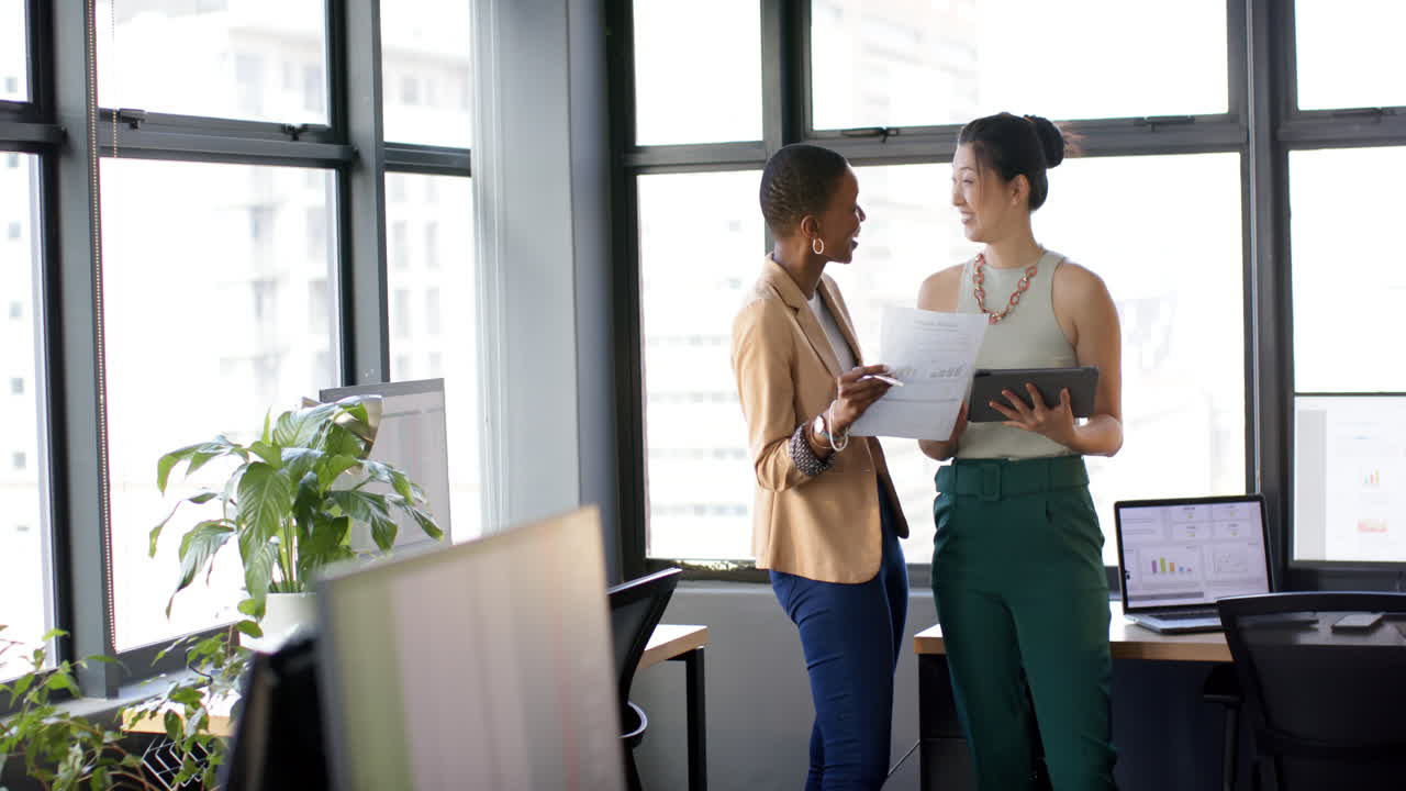 Diverse business people talking and working together in office, slow motion, copy space
