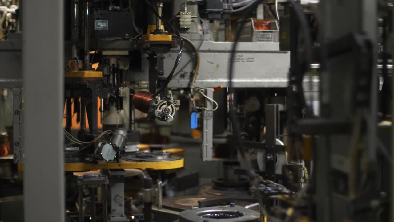 Robotic equipment moving copper wire at plant. Production electrical motors