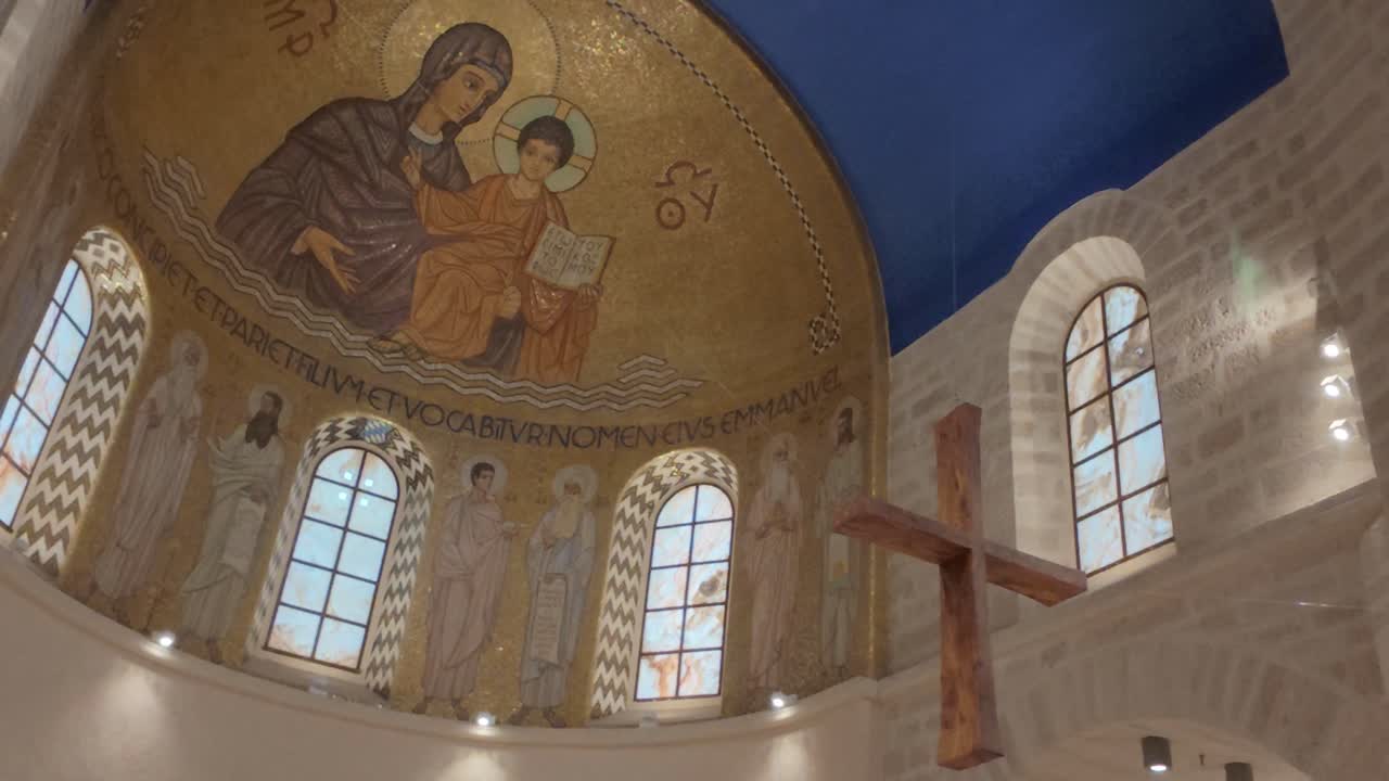 A church with a cross hanging from the ceiling in Dormition Abbey, Jerusalem old city.