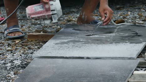 man cutting granite stone