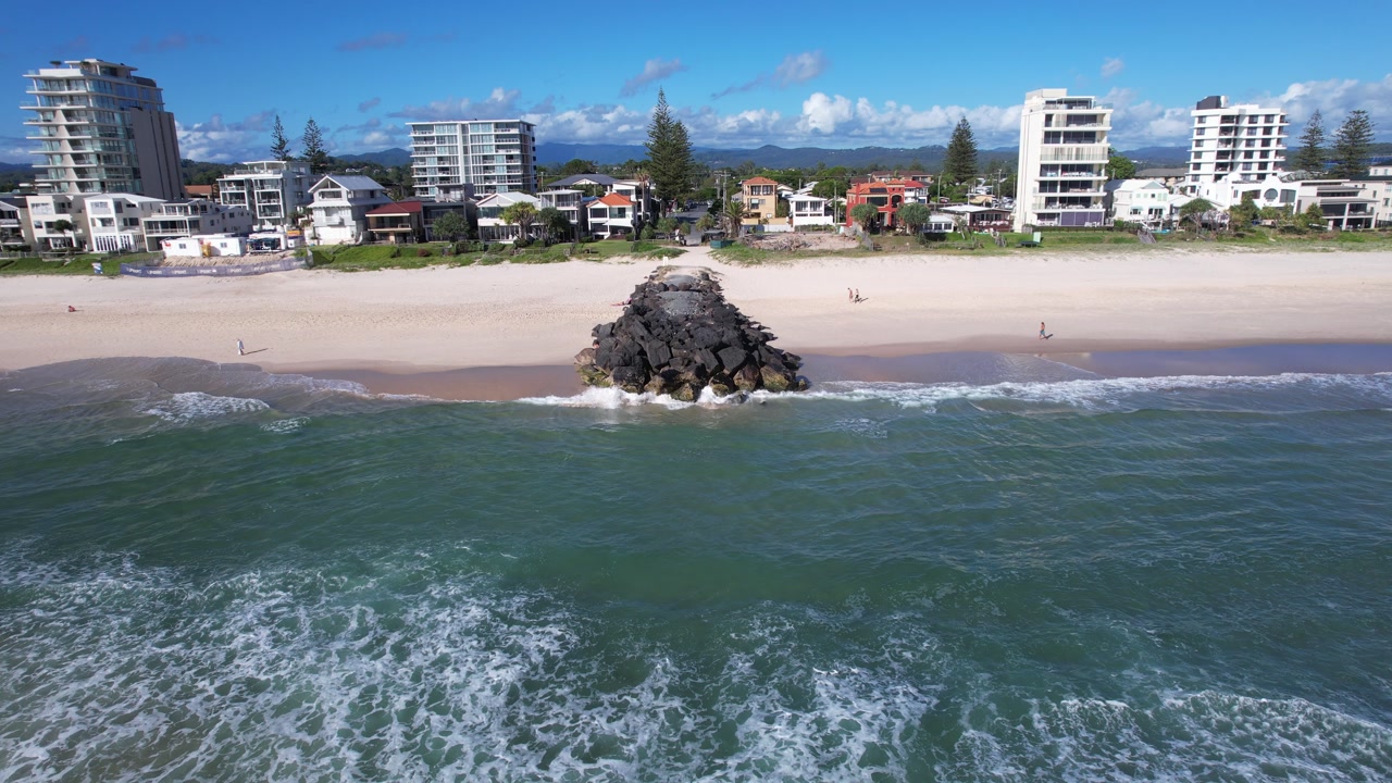 Rock Groyne Barrier On The Sandy Beach Of Palm Beach On The Gold Coast, Queensland, Australia. - aerial shot