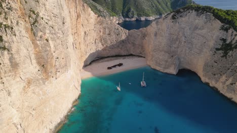 Aerial-view-of-a-mysterious-shipwreck-on-a-paradise-beach