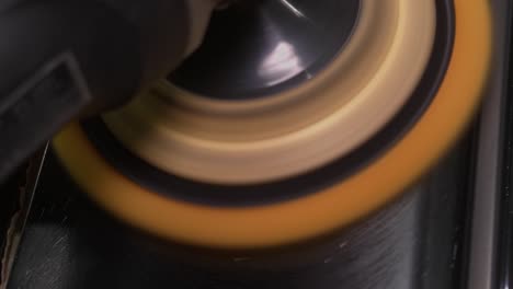 car polish with a yellow grinding machine close up in 50fps, slow motion ready